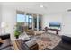 Bright living room with sliding glass doors opening to a balcony and seating area at 5430 Eagles Point Cir # 101, Sarasota, FL 34231