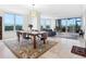 Spacious living and dining area with water views, ample natural light, and stylish furnishings at 5430 Eagles Point Cir # 101, Sarasota, FL 34231