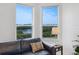 Cozy living room area with waterfront views from two windows and comfortable seating at 5430 Eagles Point Cir # 101, Sarasota, FL 34231