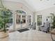 Inviting lobby area featuring comfortable seating, tile floors, and large glass entry doors at 5430 Eagles Point Cir # 101, Sarasota, FL 34231