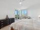 Spacious main bedroom with terrace access, ceiling fan, and sitting area at 5430 Eagles Point Cir # 101, Sarasota, FL 34231