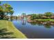 Scenic view of houses with fountains in a pond, showing a peaceful community and well-maintained landscaping at 5430 Eagles Point Cir # 101, Sarasota, FL 34231