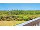 A lush green landscape is visible from the balcony overlooking the tree line at 5430 Eagles Point Cir # 101, Sarasota, FL 34231