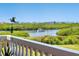 Water view from the balcony features a boat traveling down the river near mangroves at 5430 Eagles Point Cir # 101, Sarasota, FL 34231