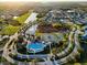 An aerial view of the community shows the pool, clubhouse, tennis courts, and lakefront homes at 5439 74Th E Pl, Ellenton, FL 34222