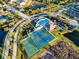 Aerial view showcases community amenities, including the pool, playground, tennis courts, and basketball court at 5439 74Th E Pl, Ellenton, FL 34222