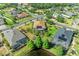 Beautiful aerial view of a home with a screened-in pool and lush landscaping in a quiet neighborhood at 5439 74Th E Pl, Ellenton, FL 34222