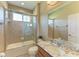 Bathroom featuring a granite-topped vanity, a toilet and a tub and shower with tile surround at 5439 74Th E Pl, Ellenton, FL 34222