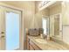 Bathroom featuring a granite-topped vanity with basket and a door leading to the outside at 5439 74Th E Pl, Ellenton, FL 34222