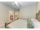 Bedroom with a ceiling fan, light-colored walls, carpeted floor and doors leading to a bathroom and closet at 5439 74Th E Pl, Ellenton, FL 34222