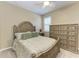 Bedroom featuring wood furnishings including a bed with throw pillows, a ceiling fan and a dresser at 5439 74Th E Pl, Ellenton, FL 34222