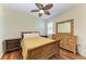 Bedroom with a ceiling fan, hard wood floors and wood furnishings including a bed and dresser at 5439 74Th E Pl, Ellenton, FL 34222