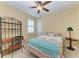 A cozy bedroom featuring a colorful bedspread, shelving, ceiling fan and a window at 5439 74Th E Pl, Ellenton, FL 34222
