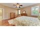 Cozy bedroom with ceiling fan, wood flooring, and natural light from two windows at 5439 74Th E Pl, Ellenton, FL 34222