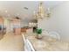 Open dining area features chandelier lighting, table with seating, and views of the adjacent kitchen at 5439 74Th E Pl, Ellenton, FL 34222