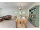 A dining room with light wood table and chairs, plus an antique green china cabinet for storage at 5439 74Th E Pl, Ellenton, FL 34222