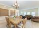 Open-concept dining and living area with natural light and ample seating and wood flooring at 5439 74Th E Pl, Ellenton, FL 34222