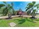 Well-manicured lawn, lush landscaping, an American flag, and paver driveway at 5439 74Th E Pl, Ellenton, FL 34222