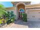Charming front entrance featuring stone accents, manicured landscaping, and a brick paver walkway at 5439 74Th E Pl, Ellenton, FL 34222