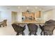 Kitchen with a bar top, light wood cabinets and a view into the dining room at 5439 74Th E Pl, Ellenton, FL 34222