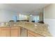 Kitchen counter featuring granite countertops, stainless steel appliances and seating at the breakfast bar at 5439 74Th E Pl, Ellenton, FL 34222