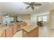 Open concept kitchen with stainless steel appliances, kitchen island and view to dining room at 5439 74Th E Pl, Ellenton, FL 34222
