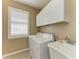 Laundry room featuring a washer, dryer, window with plantation shutters and a utility sink at 5439 74Th E Pl, Ellenton, FL 34222
