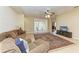 Comfortable living room with a ceiling fan, and sliding glass doors leading to an outdoor area at 5439 74Th E Pl, Ellenton, FL 34222