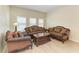 Cozy living room with comfortable seating, a wood floor, and bright natural light from the windows at 5439 74Th E Pl, Ellenton, FL 34222