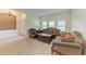 Warm and inviting living room with wood flooring, natural lighting, and a traditional furniture set at 5439 74Th E Pl, Ellenton, FL 34222