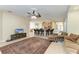Spacious living area with views of kitchen bar seating, open layout with tile floors and ceiling fan at 5439 74Th E Pl, Ellenton, FL 34222