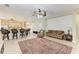 Bright, open-concept living space with a ceiling fan, breakfast bar seating, and ample living space at 5439 74Th E Pl, Ellenton, FL 34222