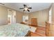Bedroom with wood floors, ceiling fan, natural light, and an open doorway to the living spaces at 5439 74Th E Pl, Ellenton, FL 34222