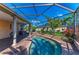Screened in pool with brick pavers, lush landscaping, and covered patio are visible at 5439 74Th E Pl, Ellenton, FL 34222