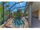 Relaxing screened-in spa with brick pavers and plenty of room for entertaining with lush tropical landscaping at 5439 74Th E Pl, Ellenton, FL 34222