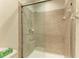 A glass enclosed shower featuring tile surround, a shower head, and grab bar for support at 5439 74Th E Pl, Ellenton, FL 34222