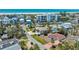 Aerial view of home near a beach featuring a white exterior, brick driveway, and mature landscaping at 5522 Calle Del Verano, Sarasota, FL 34242