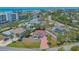 This aerial view shows a home with mature landscaping, a brick driveway, and nearby amenities at 5522 Calle Del Verano, Sarasota, FL 34242