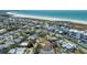 Aerial view of a coastal community with beach access and lush landscaping, highlighting the proximity to the water at 5522 Calle Del Verano, Sarasota, FL 34242