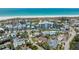 Aerial view of a coastal community with a white sandy beach with neighborhood, highlighting the location at 5522 Calle Del Verano, Sarasota, FL 34242