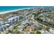 Stunning aerial view of a coastal community featuring beautiful homes, and a beach nearby at 5522 Calle Del Verano, Sarasota, FL 34242