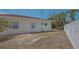 View of the backyard shows the exterior of the home and limited landscaping at 5522 Calle Del Verano, Sarasota, FL 34242