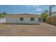 Rear view of the home showing a screened-in porch and minimal landscaping at 5522 Calle Del Verano, Sarasota, FL 34242