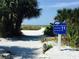 Siesta Beach public access path with lush tropical foliage leading to the white sandy beach at 5522 Calle Del Verano, Sarasota, FL 34242