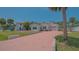 Charming single-story home with a brick driveway and well-maintained lawn, creating a welcoming curb appeal at 5522 Calle Del Verano, Sarasota, FL 34242