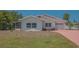Charming single-story home with a light exterior, a garage, and a brick driveway at 5522 Calle Del Verano, Sarasota, FL 34242