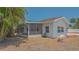 Exterior view of home with a screened in porch and small garden in the back yard at 5522 Calle Del Verano, Sarasota, FL 34242