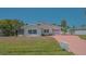 Charming single-story home with a brick driveway and well-maintained lawn at 5522 Calle Del Verano, Sarasota, FL 34242