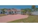 Charming single-story home with a brick driveway and well-maintained lawn at 5522 Calle Del Verano, Sarasota, FL 34242