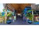 Inviting open-air restaurant with a thatched roof, colorful decor, and tropical plants inside the building at 5522 Calle Del Verano, Sarasota, FL 34242